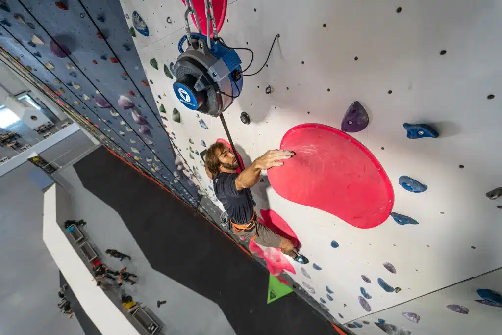 TRUBLUE Auto Belay system showcased for climbing activities, featuring advanced magnetic braking technology for safety and reliability.