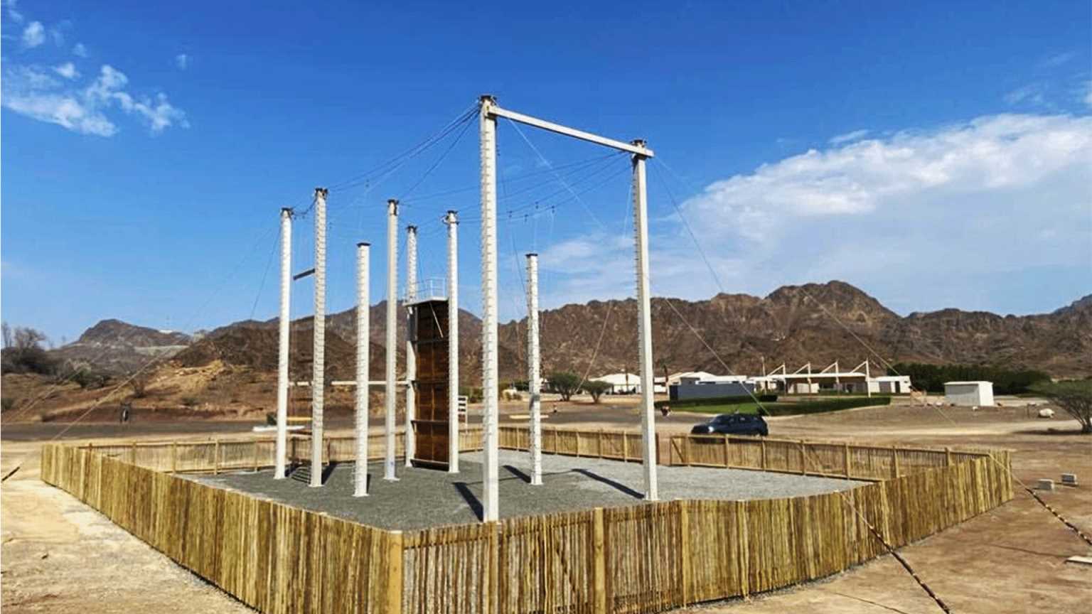 Suspended rope bridge on a high-level ropes course, designed for balance and coordination challenges in an adventurous setting.